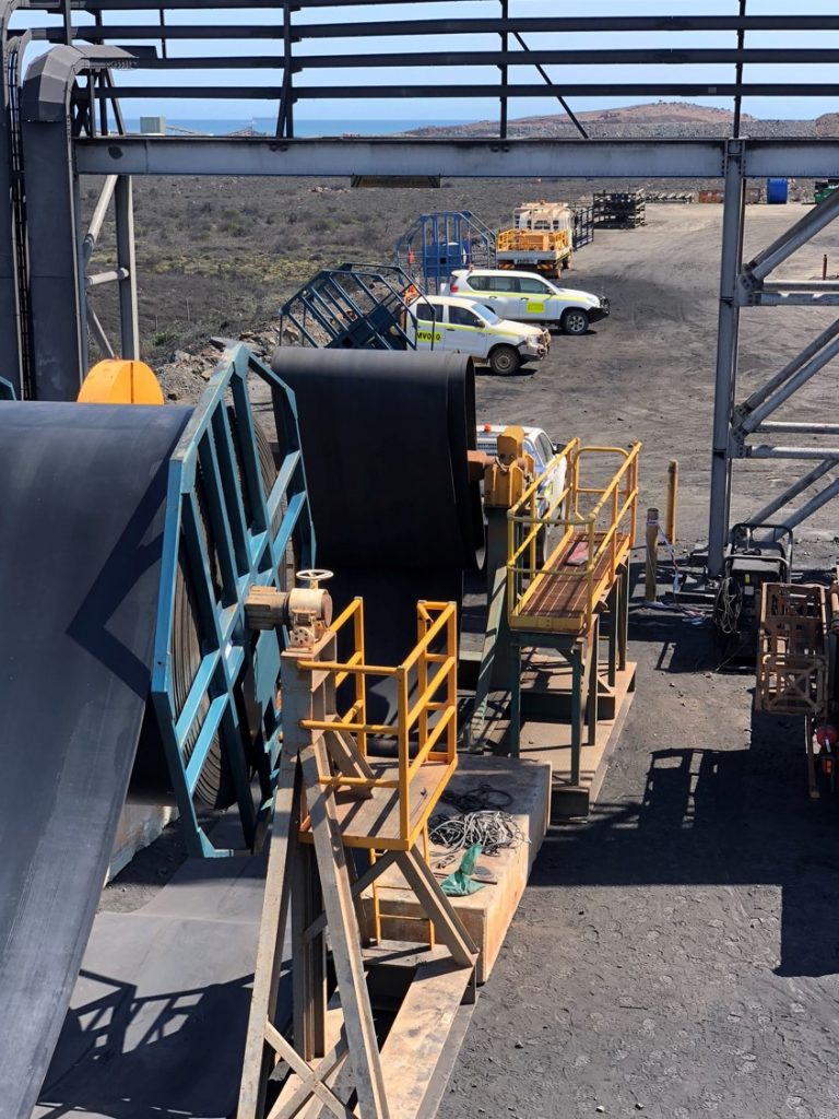 Boton Conveyor Services loading new belt onto a conveyor at a work site.