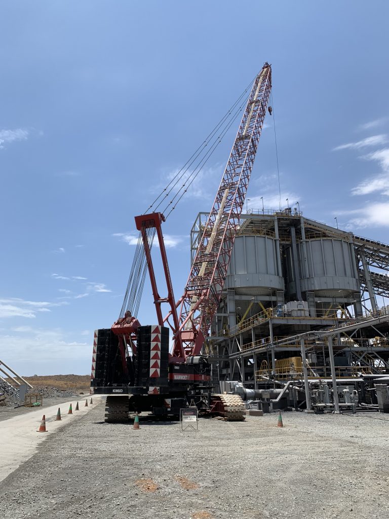 The construction site of a BCS conveyor belt, showing a crane putting the system together.