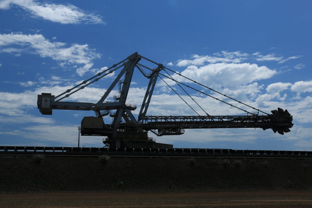 Large mining digger with blue cloudy sky in the background